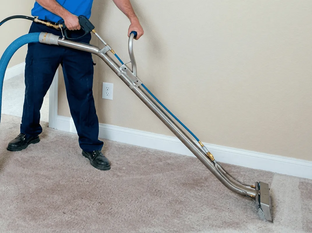 Professional operating a liquid removal machine on a carpeted floor in Little Rock, AR